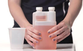 Twin chamber measuring bottle